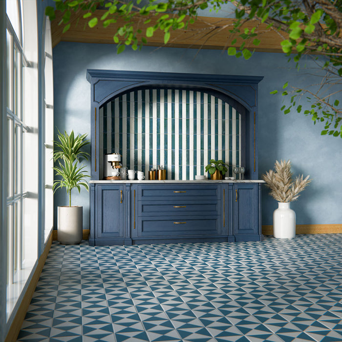 Kitchen interior featuring Allegra Blanca 6x25cm gloss brick tiles, installed vertically within a statement alcove, showcasing soft white tones with a reflective glazed finish, styled with deep blue cabinetry, brass accents, and a marble-effect worktop for a refined, elegant contrast.